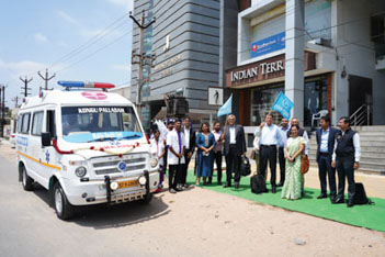 Small group standing next to mobile health care vehicle